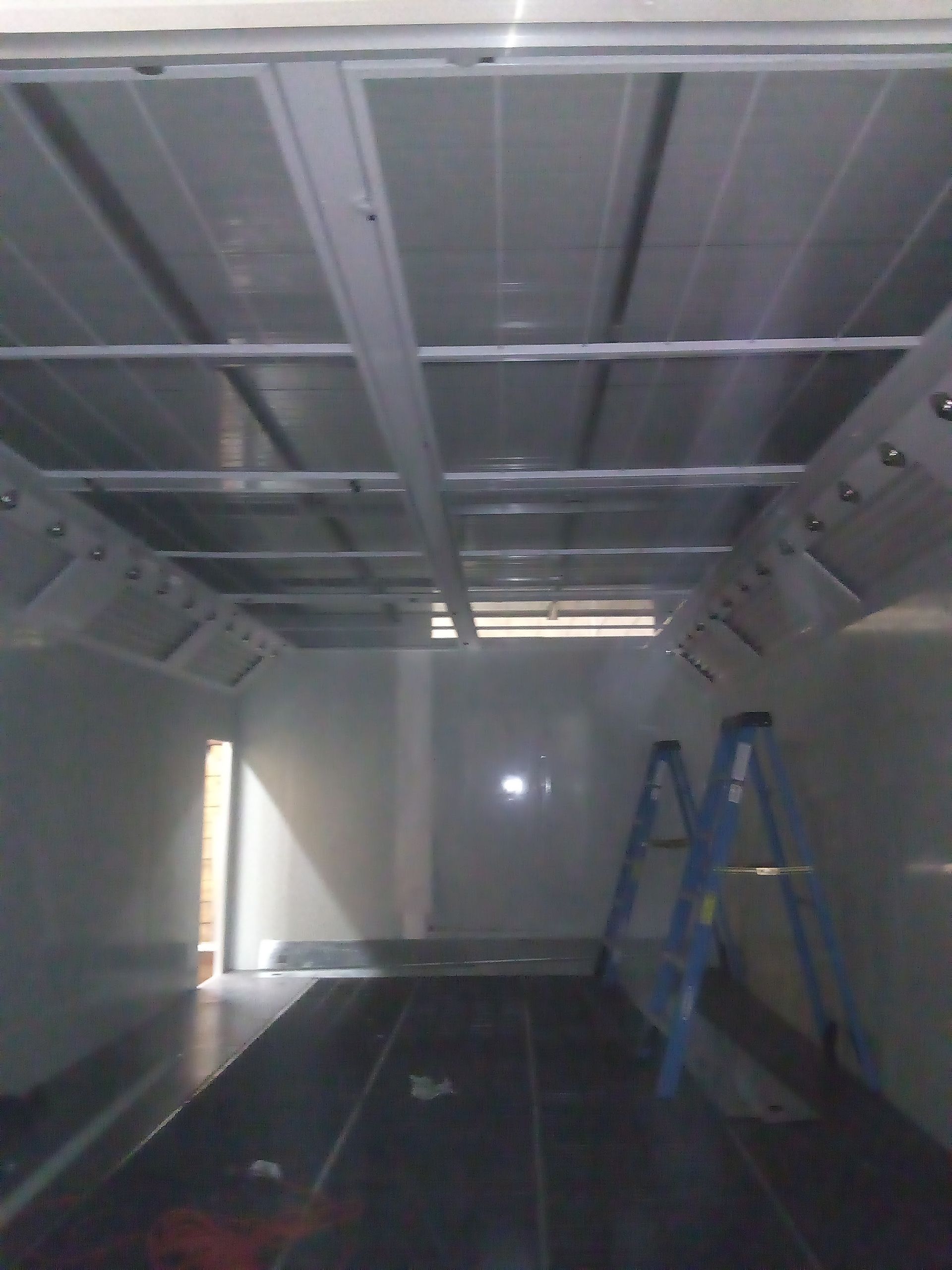 An empty room with a blue ladder in it