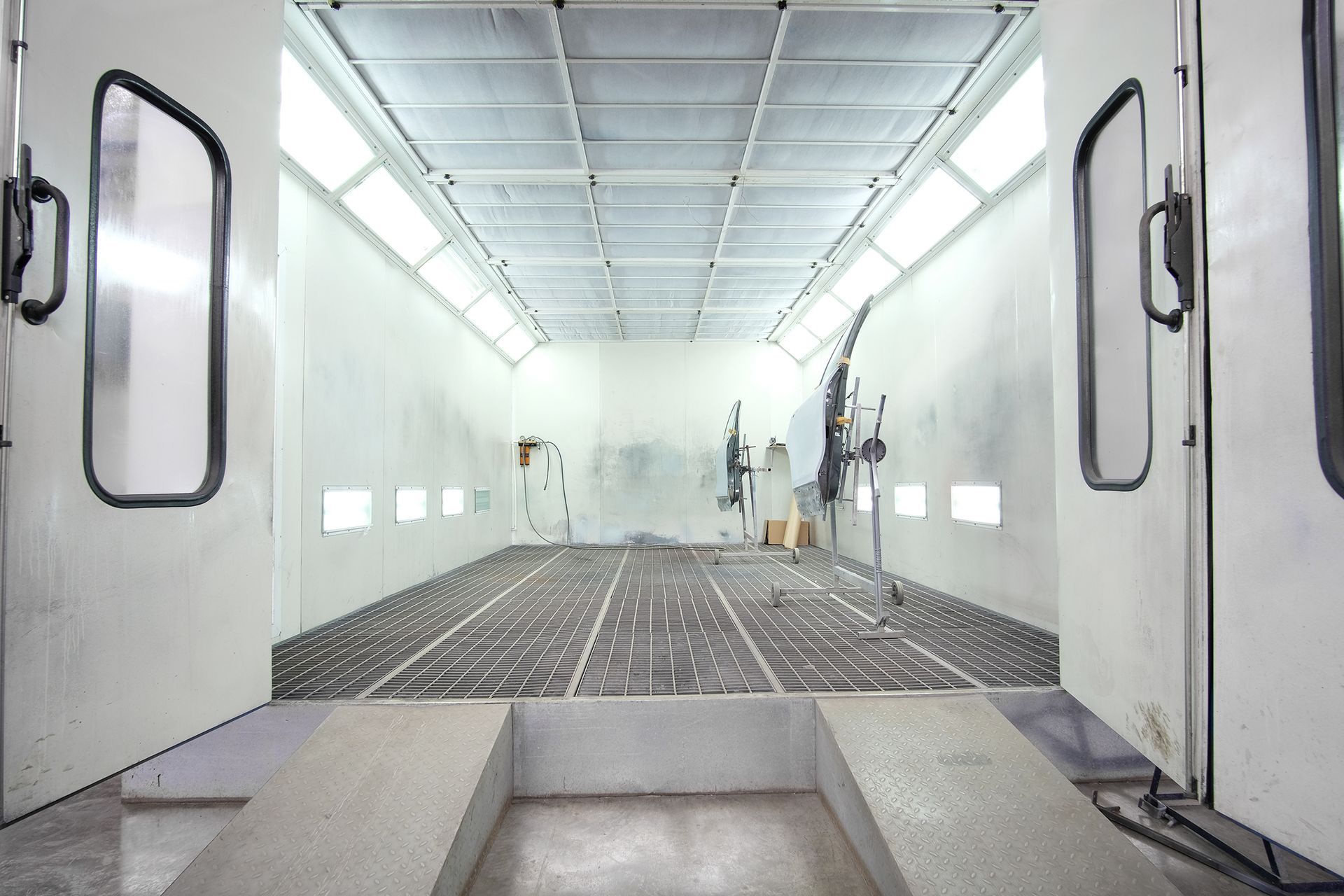 An empty paint booth with the doors open