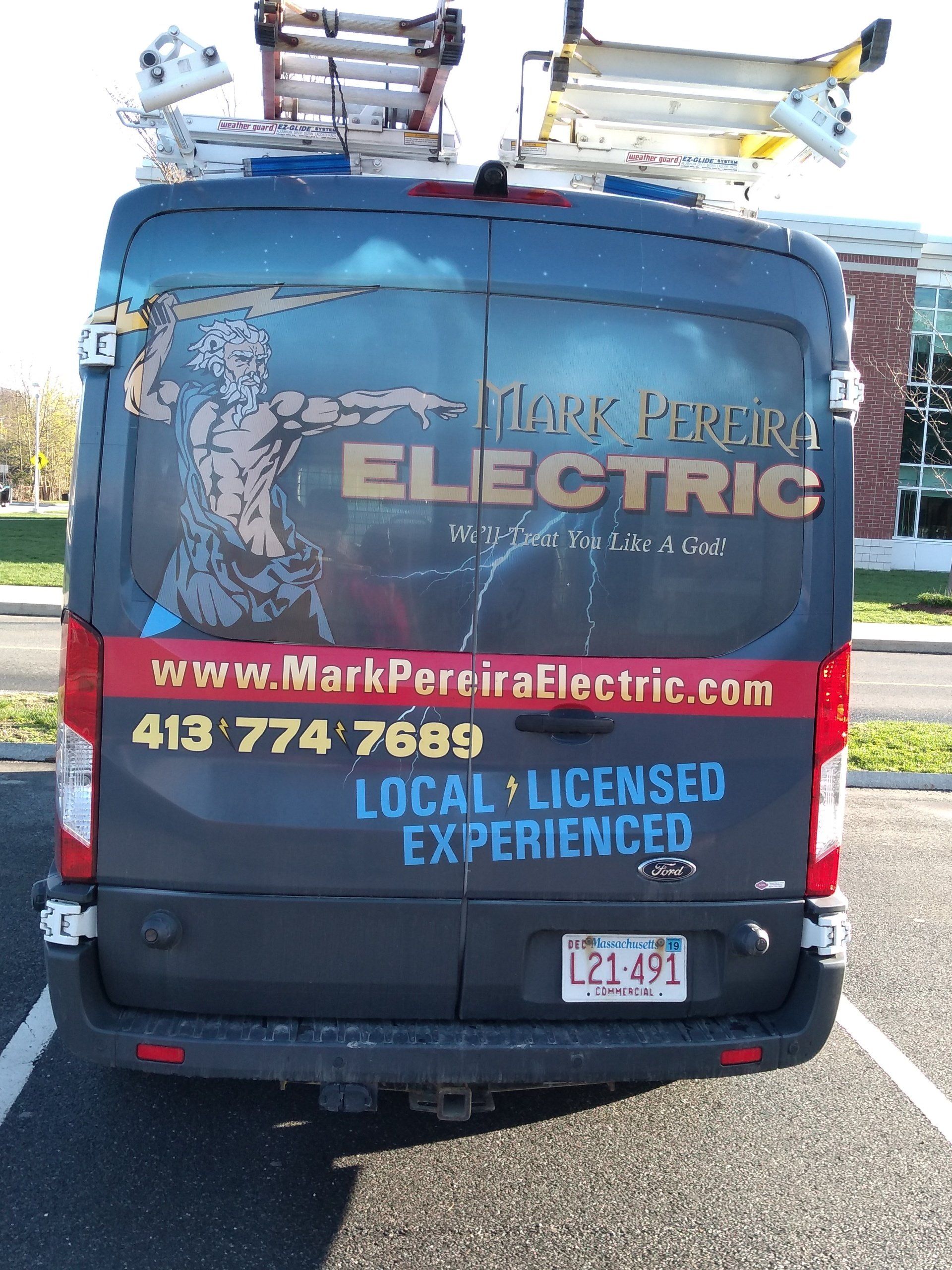 a Mark Pereira Electric van parked in a parking lot