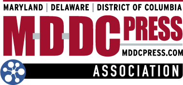Logo for the MDDC Press Association featuring bold red text, the URL mddcpress.com, and a blue network icon.