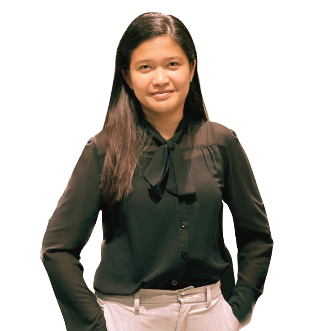 A person with dark hair wearing a long-sleeved black blouse with a neck tie, looking forward with a neutral expression.