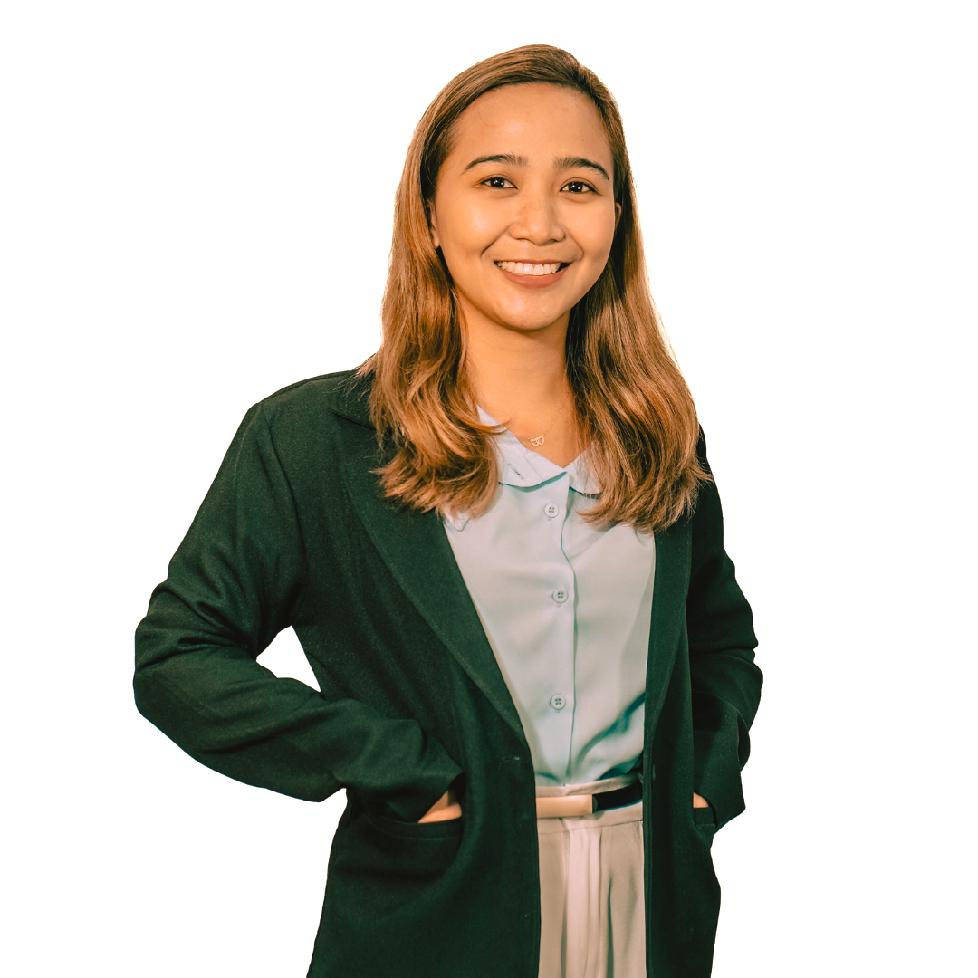 A smiling person with long light brown hair wearing a green blazer over a light blue collared shirt.