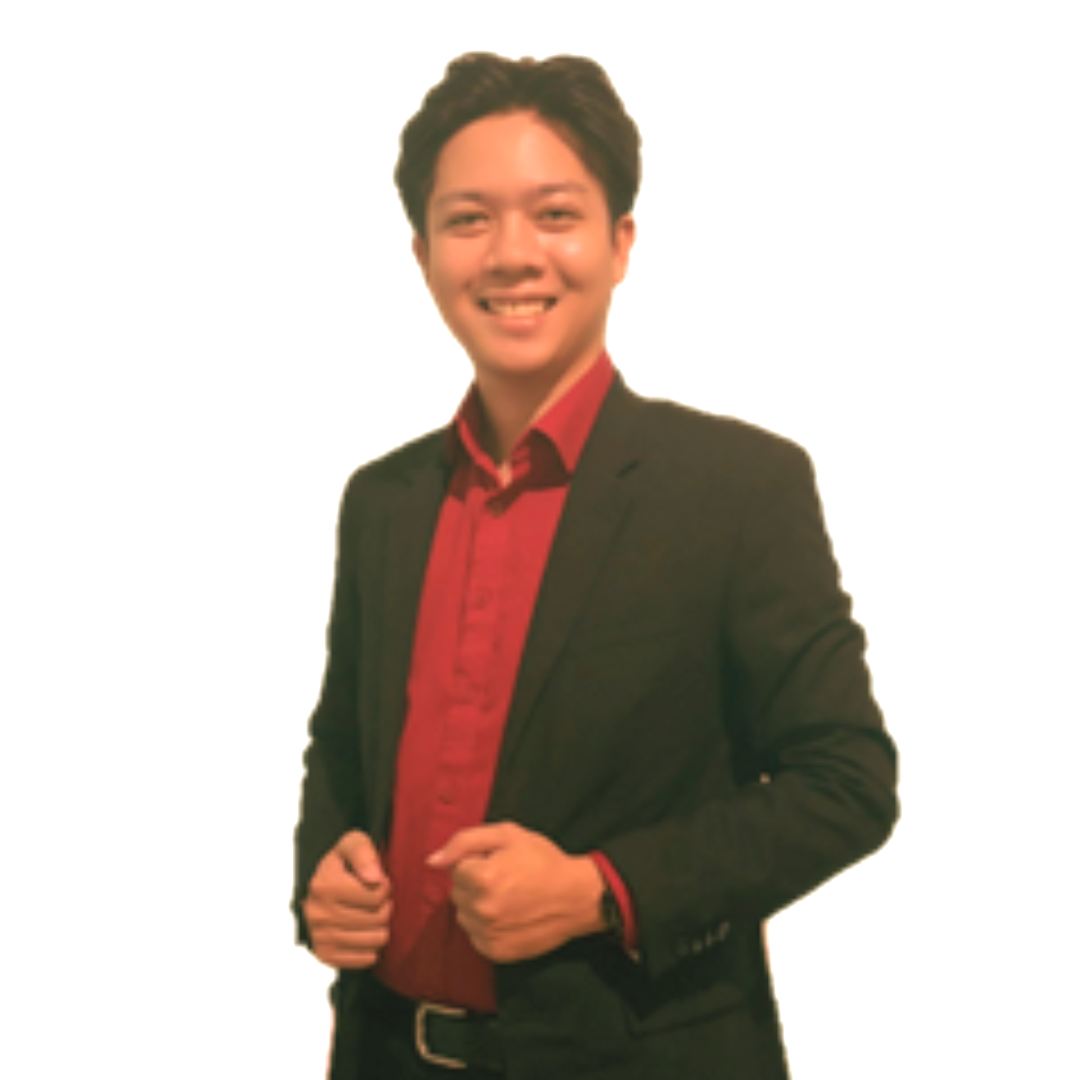 A smiling person wearing a black blazer over a red button-down shirt, standing against a plain white background.