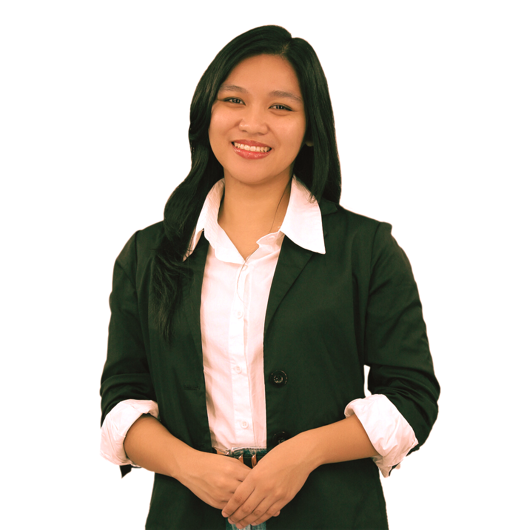 A smiling person wearing a dark green blazer over a white button-up shirt with rolled sleeves, against a white background.