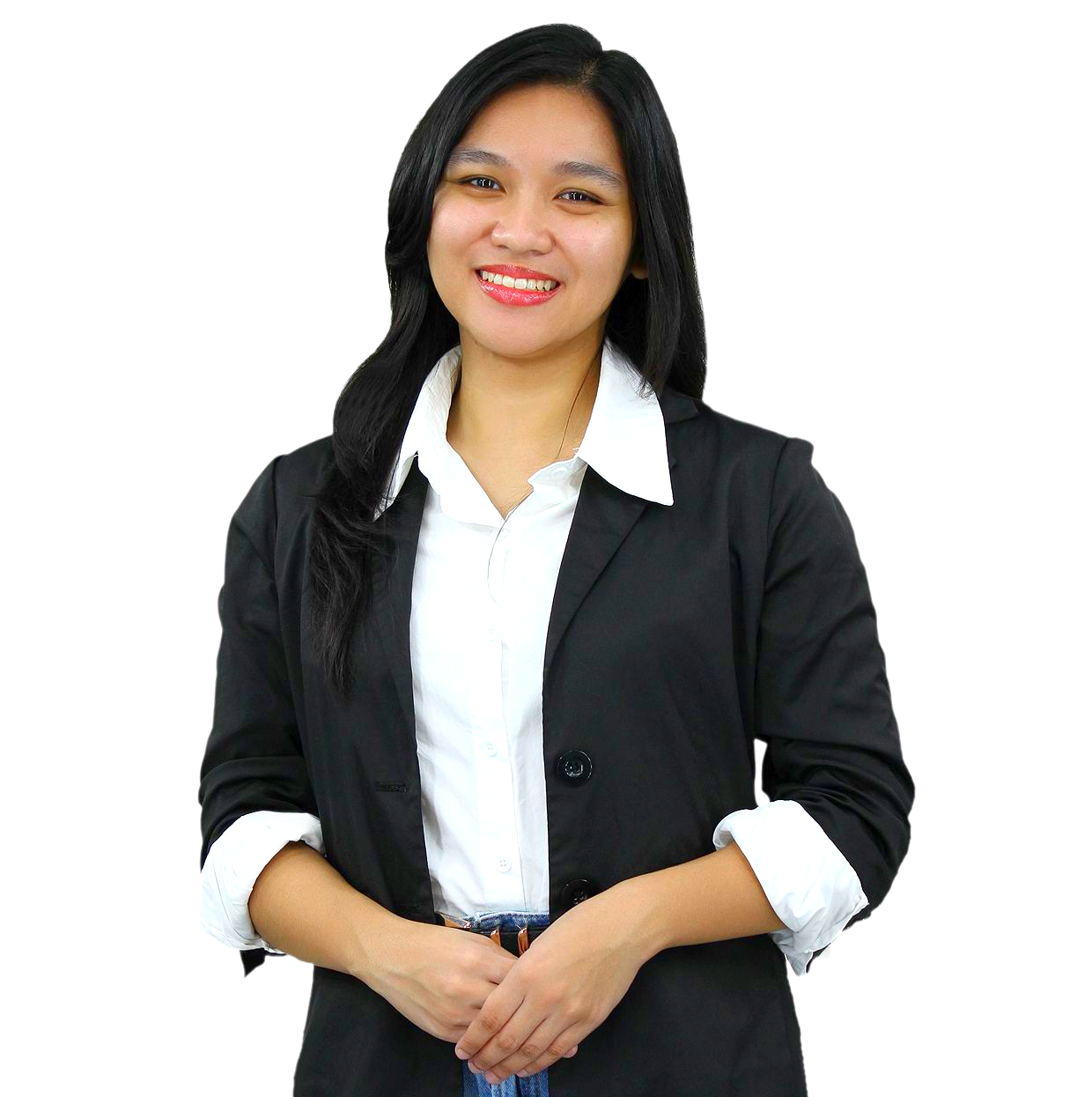 A person with dark hair wearing a white collared shirt under a dark green blazer, smiling with hands clasped in front.