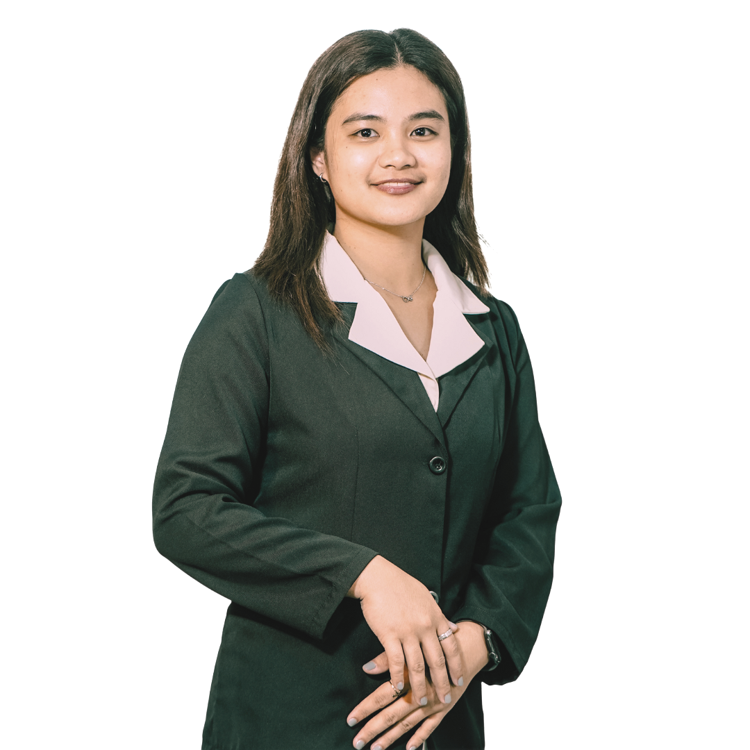 A person wearing a dark blazer over a light collared shirt, posing against a white background with hands clasped.
