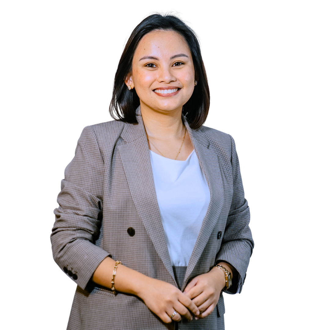 Woman smiling, wearing a gray blazer and white shirt, against a white background.