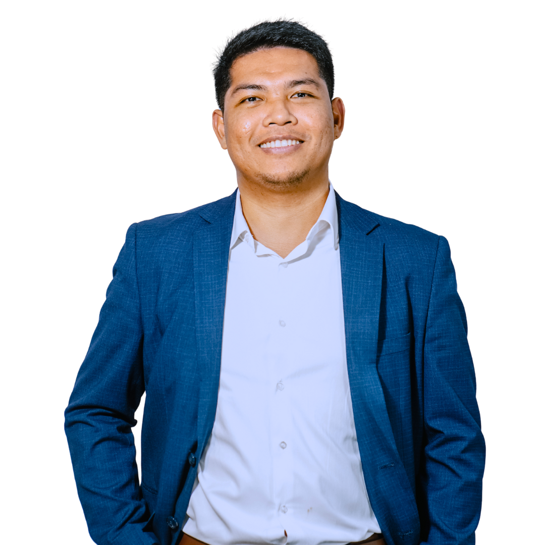 Man in blue blazer and white shirt smiles, looking at camera.