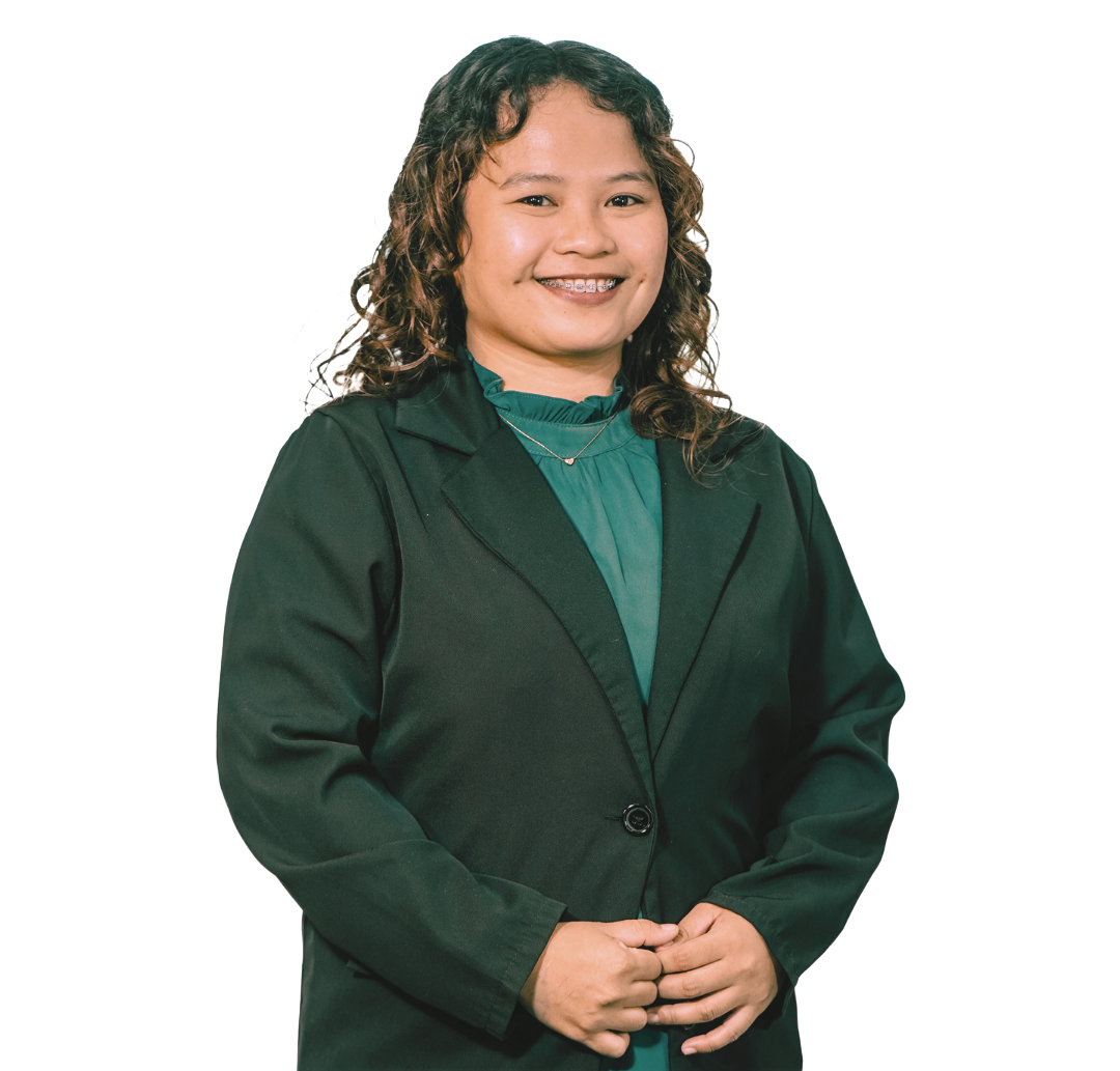 A smiling individual wearing a dark green blazer over a matching green high-neck top, posed against a white background.