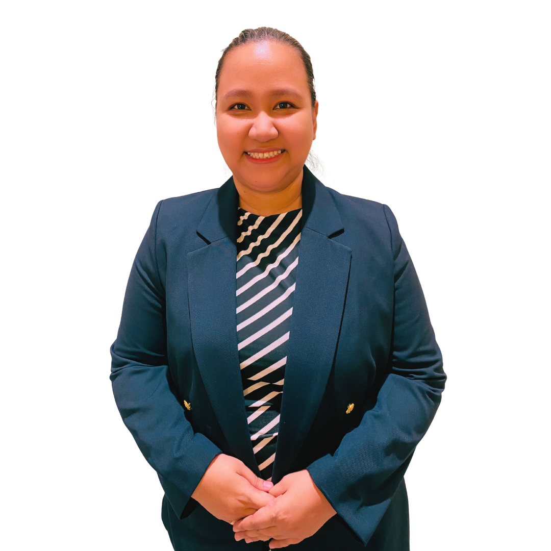 A smiling person stands against a white background wearing a dark blue blazer over a black and white striped top.