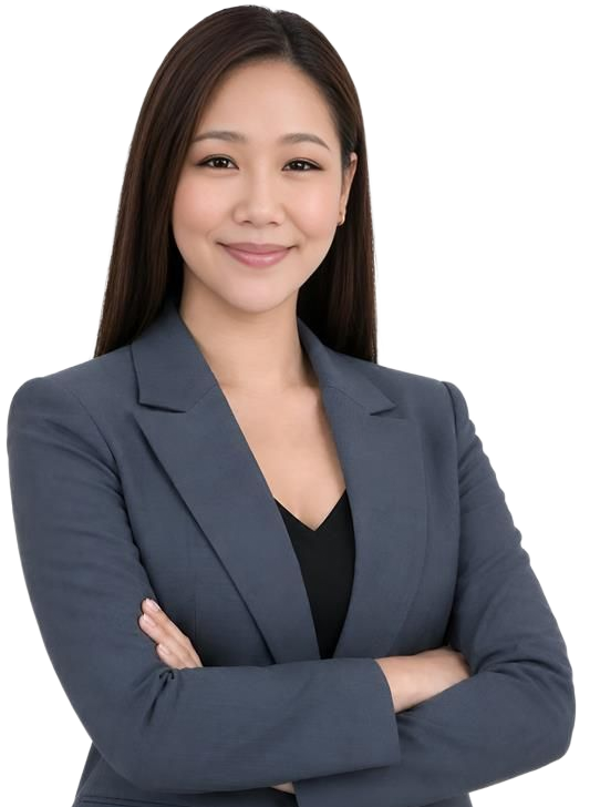 Smiling professional in a gray blazer with arms crossed against a white background