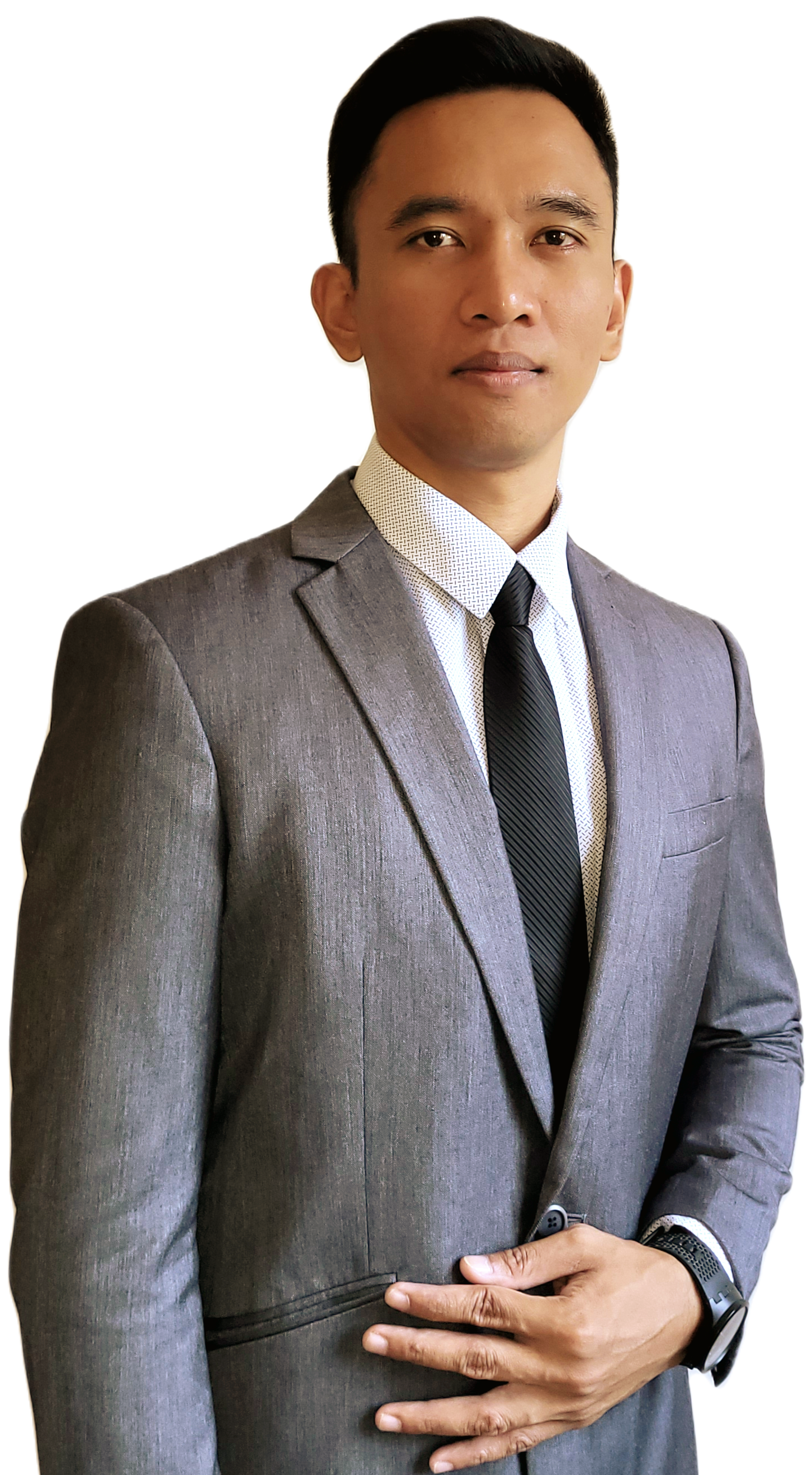 A professional headshot of a person wearing a black blazer over a brown collared shirt against a plain white background.