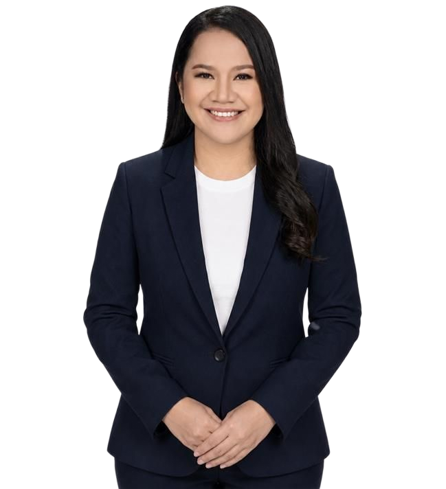 Smiling professional in a navy blazer and white shirt against a light gray background