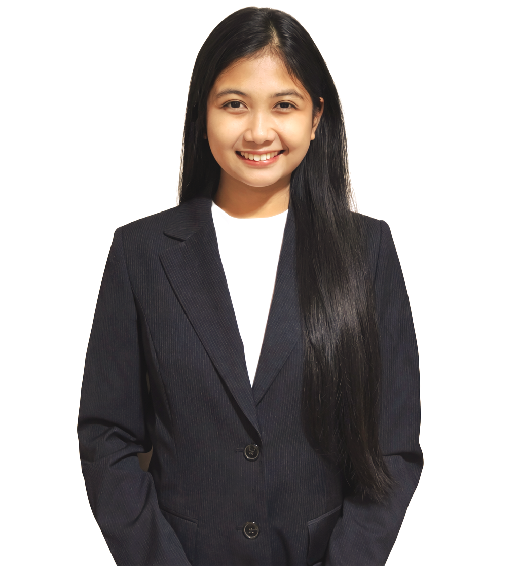 A smiling person with long dark hair, wearing a white shirt and a dark navy blue blazer against a plain white background.