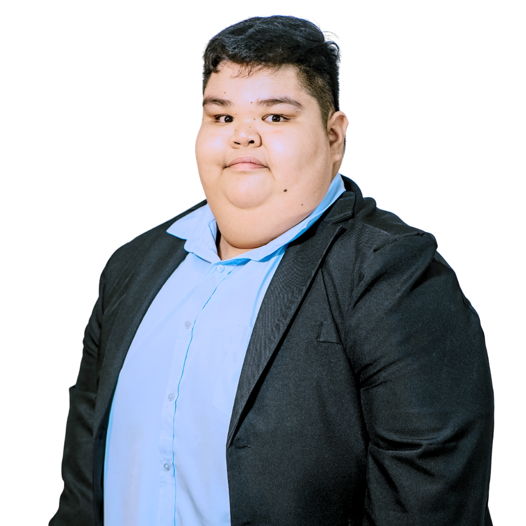 Person in a blue shirt and black blazer looks at the viewer. White background.