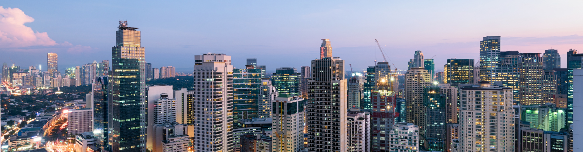 A panoramic view of a city skyline at night.