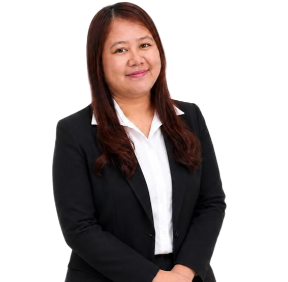 Woman in a black suit and white blouse standing against a white background, hands clasped.