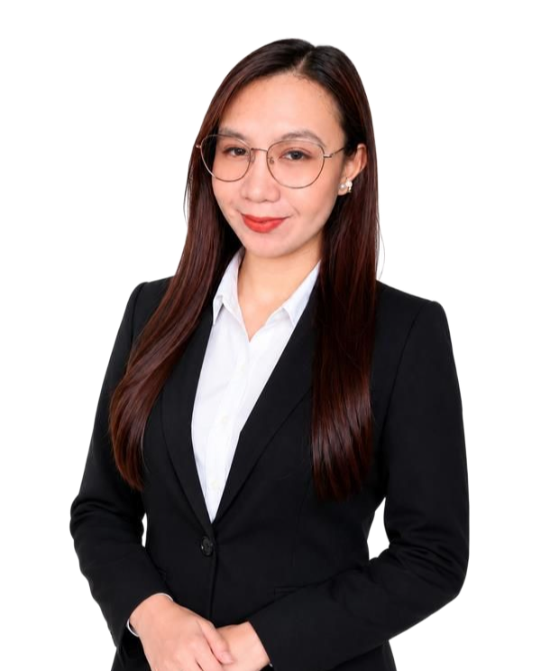 Smiling woman in a black blazer with arms crossed against a beige background