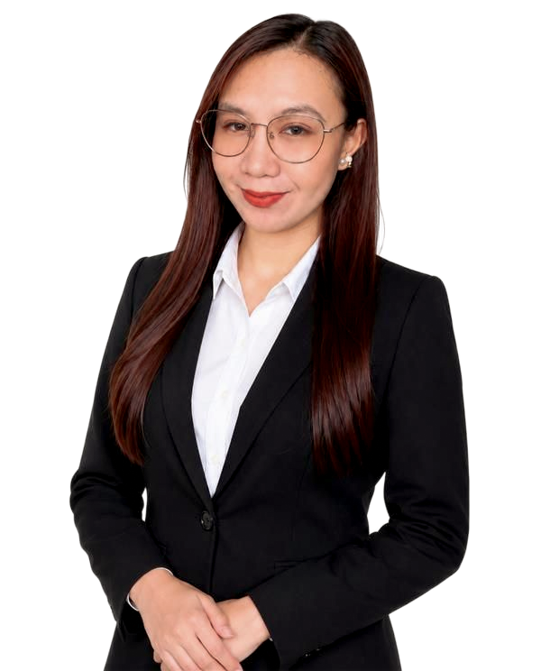 Smiling woman in a black blazer with arms crossed against a beige background