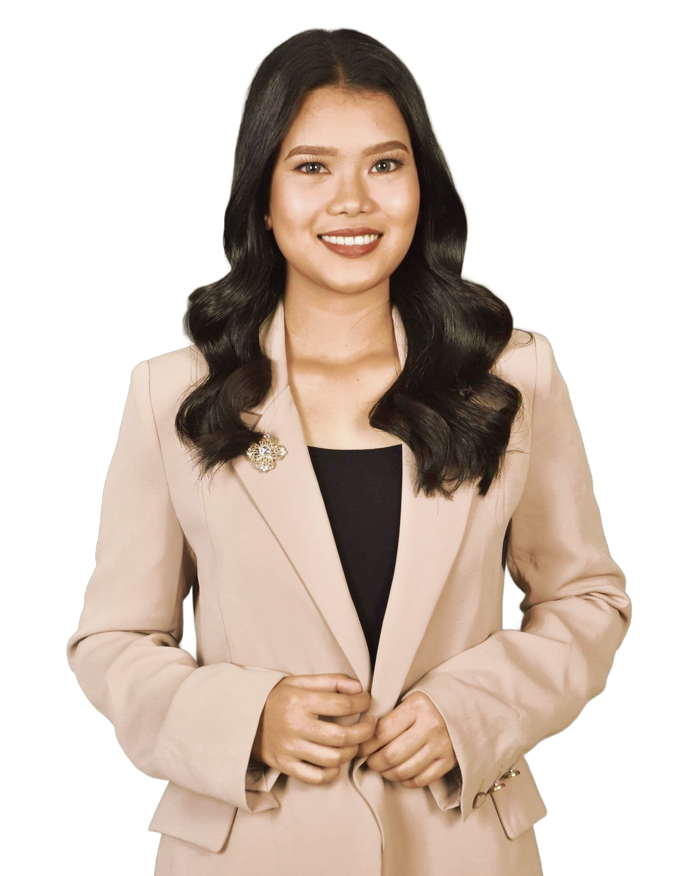 A smiling person with long dark wavy hair, wearing a tan blazer over a black top against a white background.