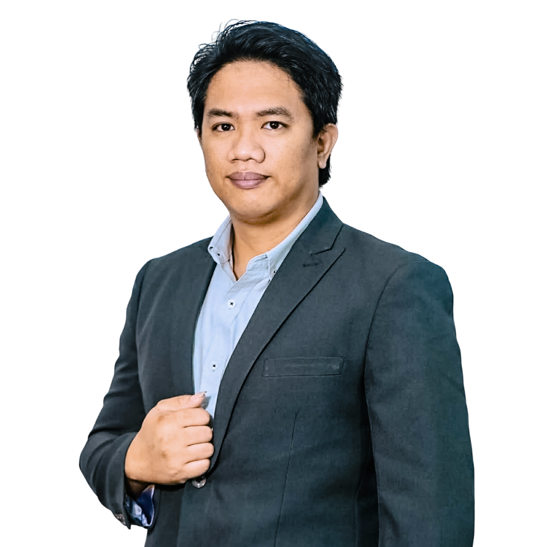 Professional headshot of a person wearing a grey suit jacket and light blue button-down shirt, isolated on white.