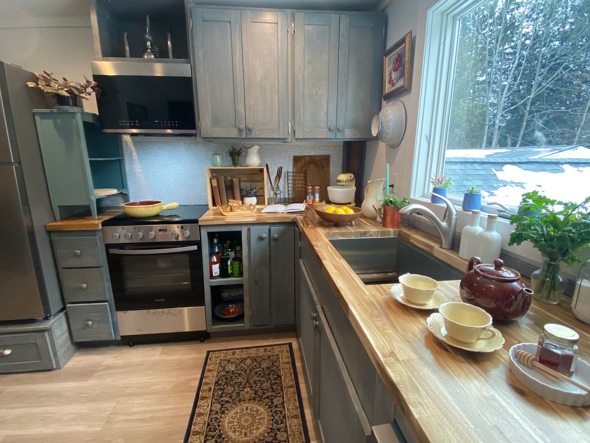 Kitchen redesign showing blue cabinets and a cozy yet tidy scene in Manchester Vermont completed by JG Services