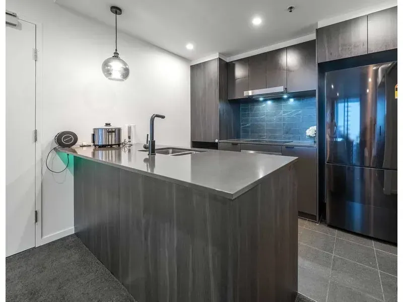 A kitchen with stainless steel appliances and a large island.