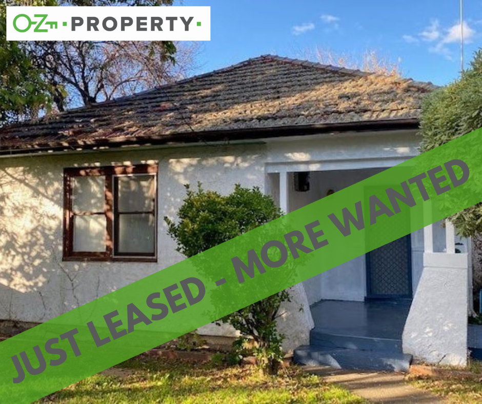 A white house with a green banner that says just leased more wanted