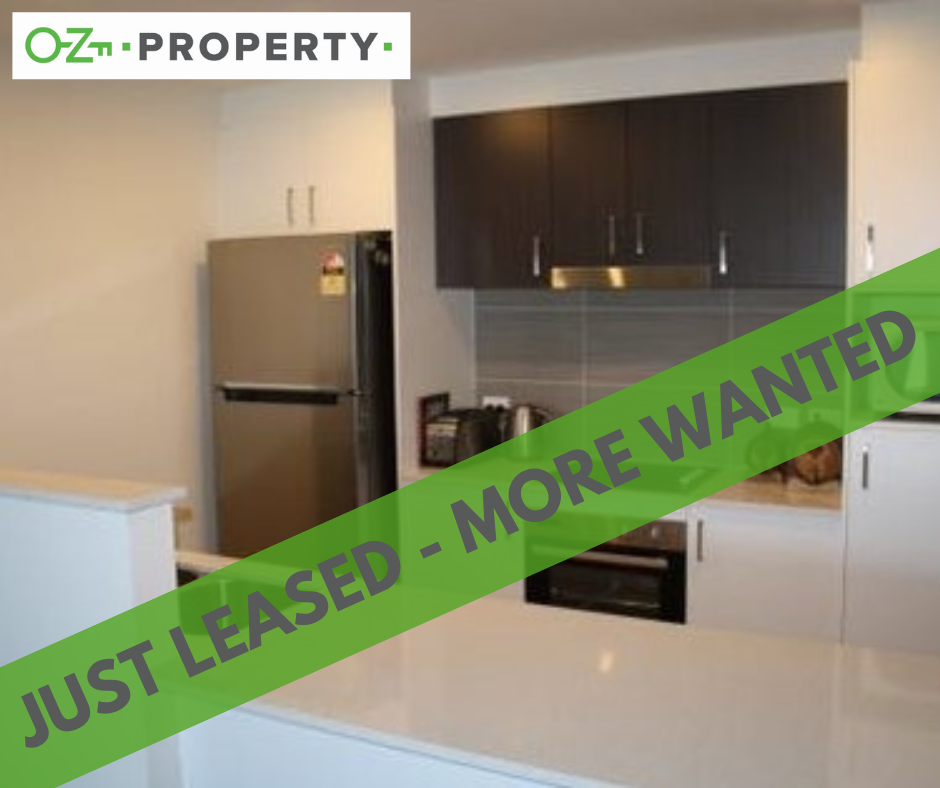 A kitchen with a sign that says just leased more wanted