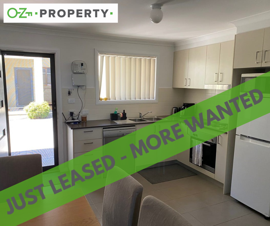 A kitchen with a sign that says just leased more wanted