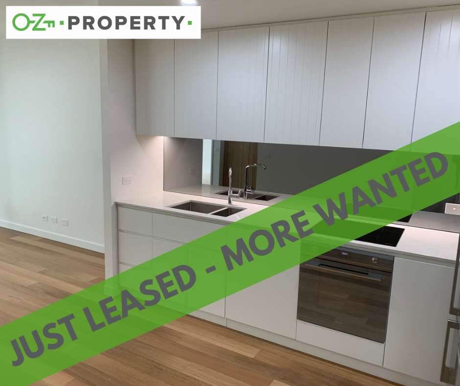 A kitchen with a green banner that says just leased more wanted