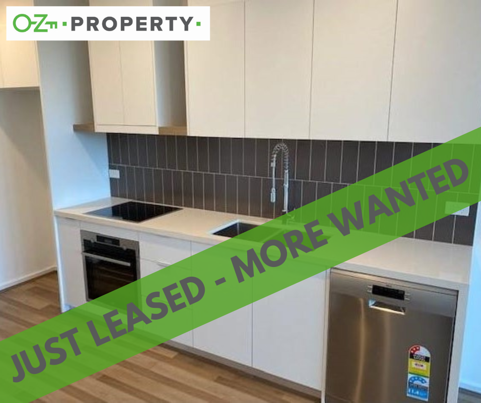 A kitchen with a green banner that says `` just leased - more wanted ''