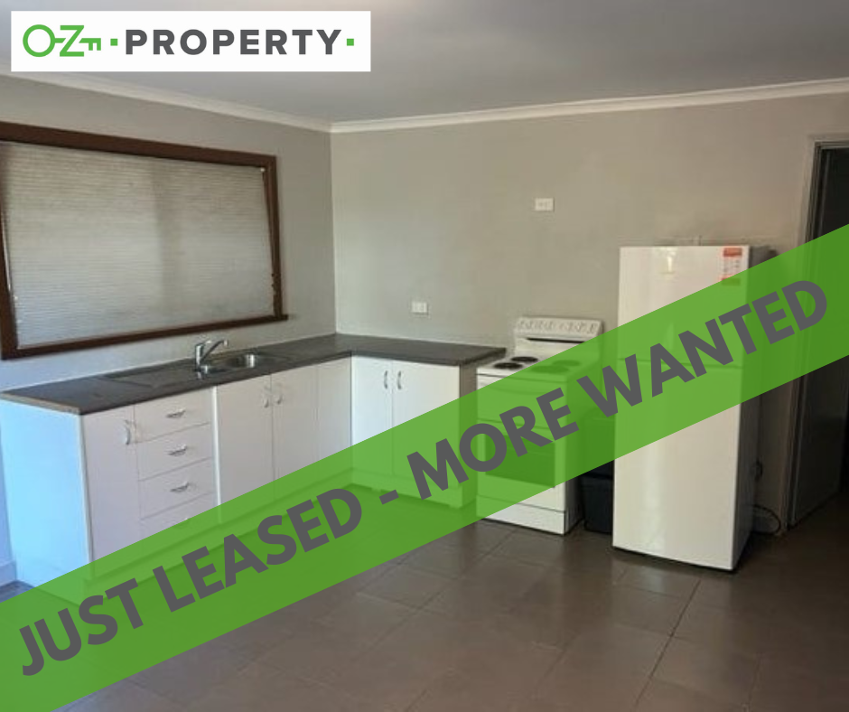 A kitchen with a sign that says just leased more wanted