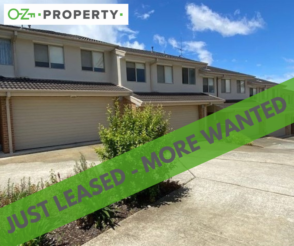 A house with a green banner that says just leased more wanted
