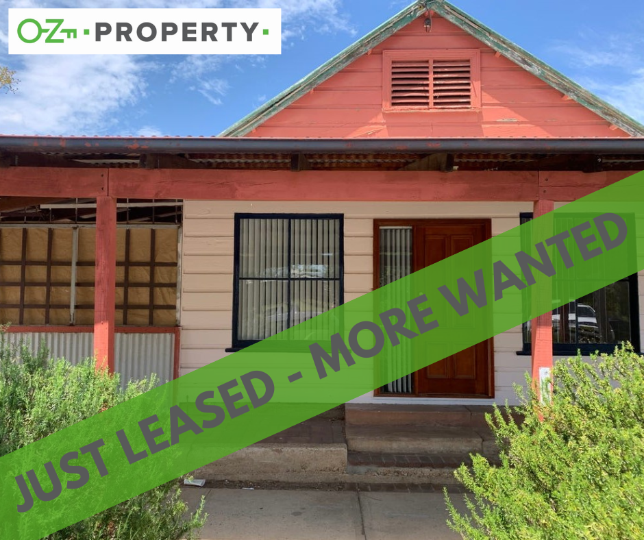 A house with a green sign that says