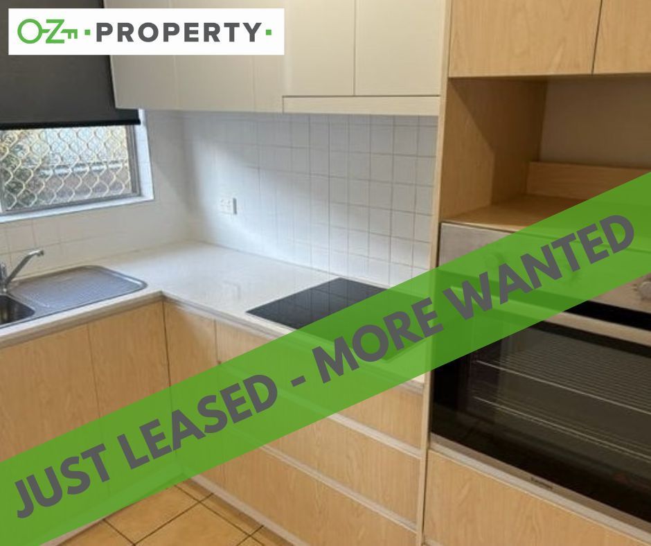 A kitchen with a green banner that says `` just leased - more wanted ''