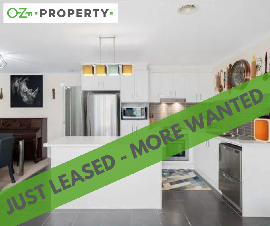 A kitchen with a green banner that says just leased more wanted