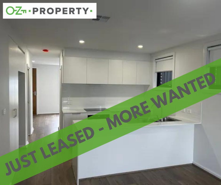 A kitchen with a green ribbon that says just leased more wanted