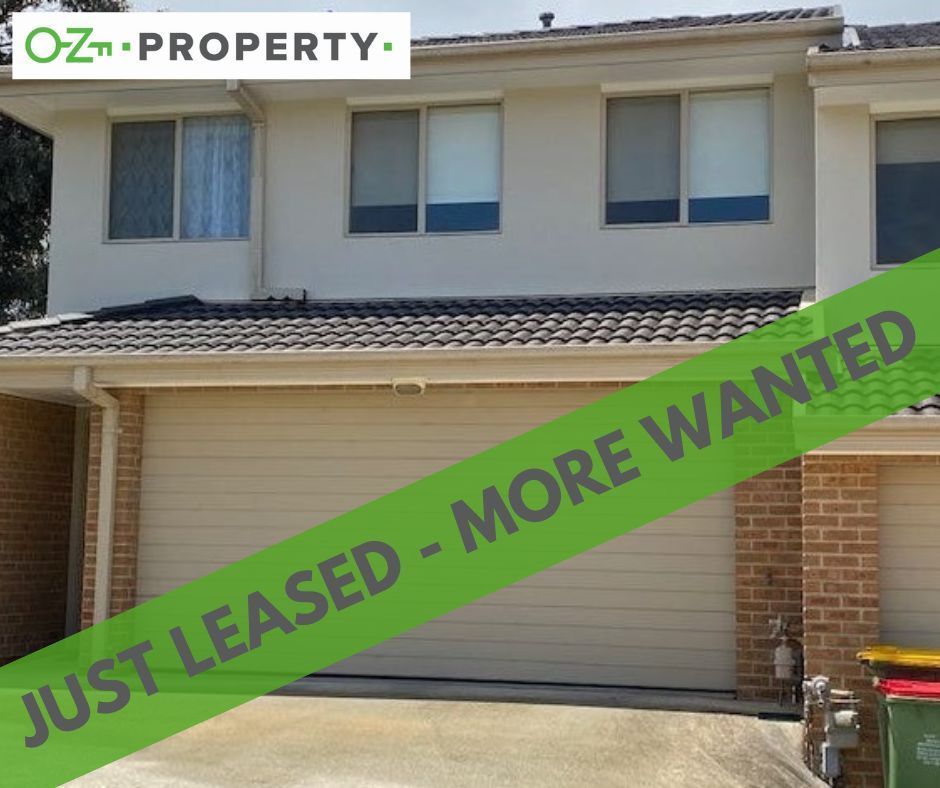 A house with a green banner that says just leased more wanted