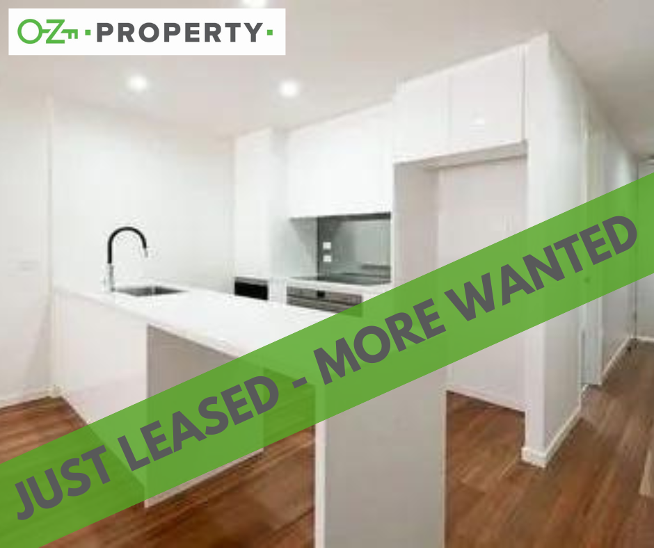 A kitchen with a green banner that says `` just leased - more wanted ''.