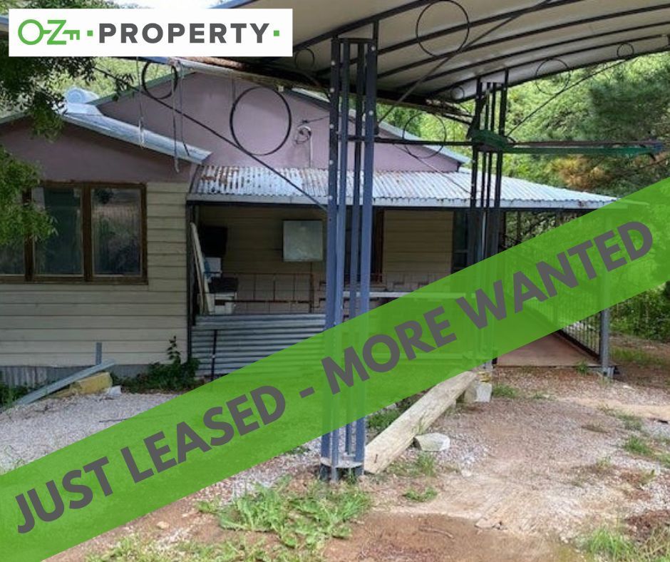 A house with a green banner that says just leased more wanted