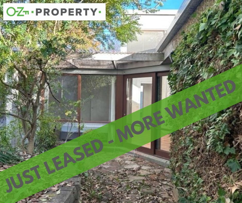 A house with a sign that says just leased more wanted
