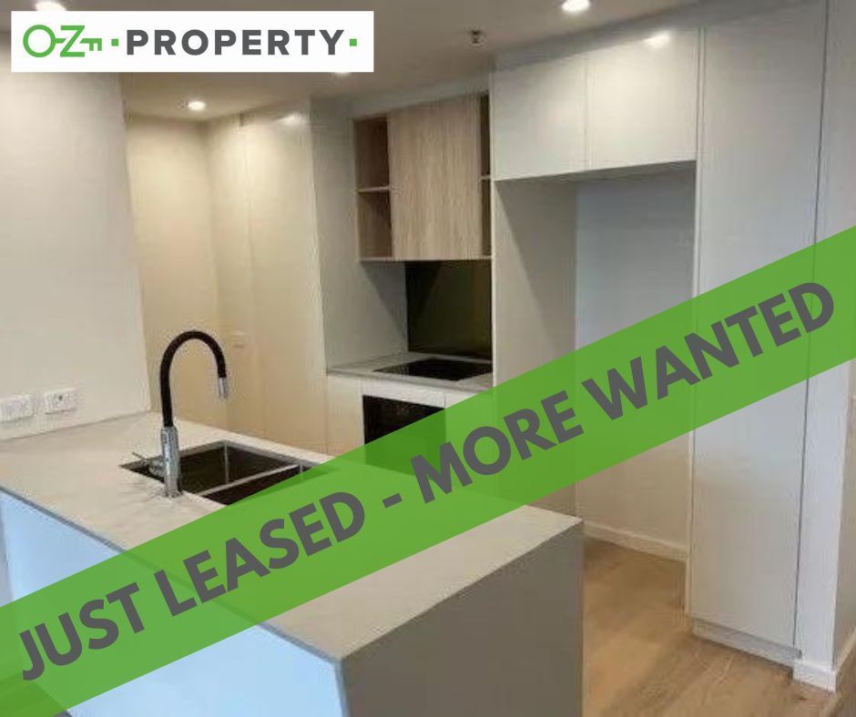 A kitchen with a green banner that says `` just leased - more wanted ''.