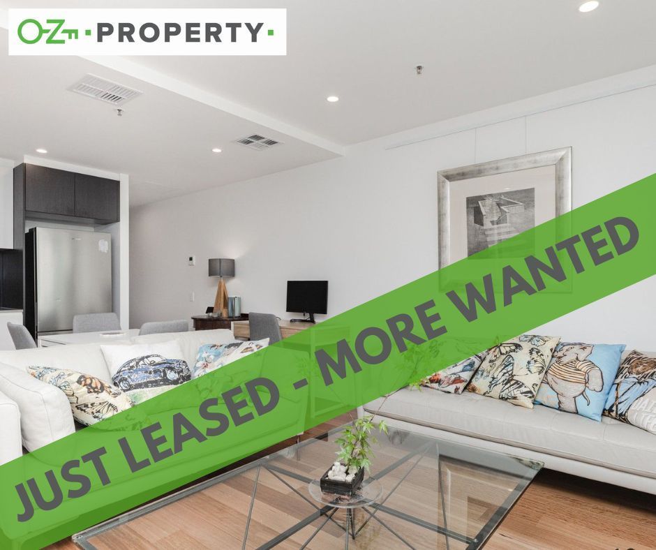 A living room with a sign that says just leased more wanted