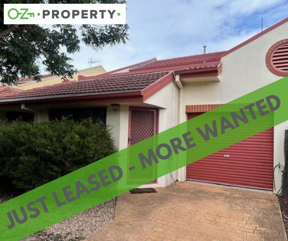 A house with a green banner that says just leased more wanted