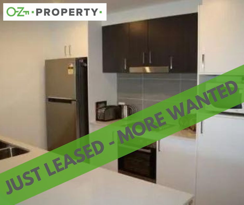 A kitchen with a sign that says `` just leased - more wanted ''