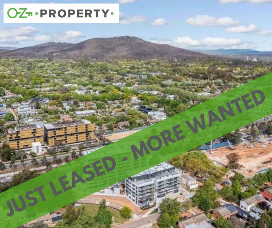 An aerial view of a city with a green tape that says `` just leased - more wanted ''.