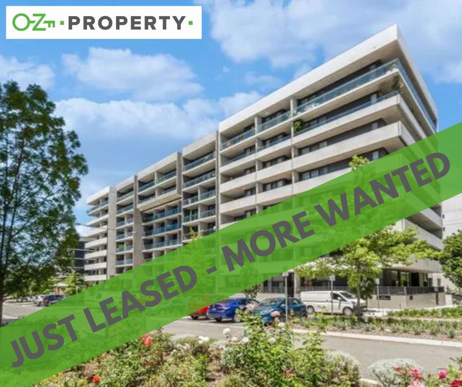 A large apartment building with a green banner that says just leased more wanted