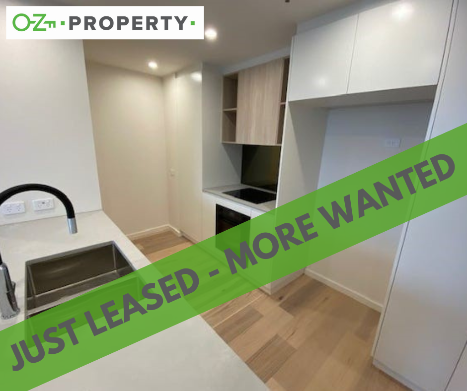 A kitchen with a green sign that says `` just leased - more wanted ''