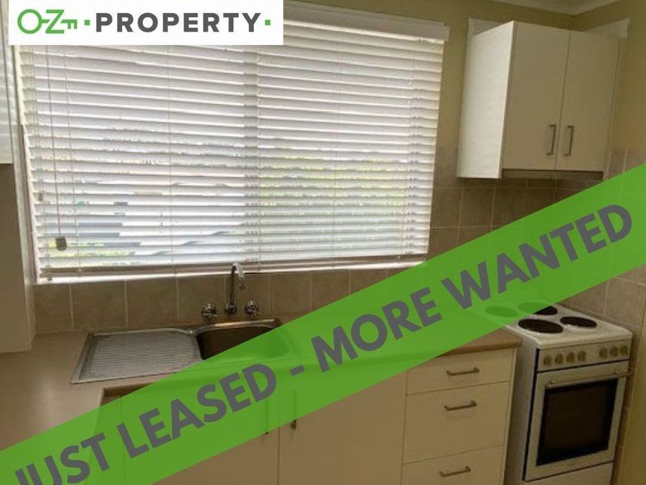 A kitchen with a sign that says